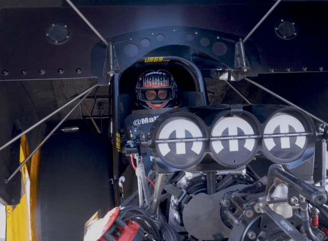 Racecar driver sitting in a top fuel dragster racecar