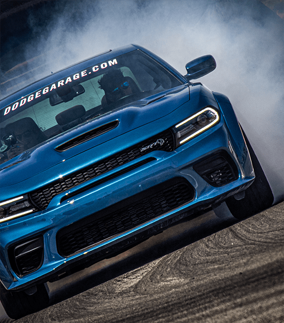 Blue Dodge Charger SRT racing on a track