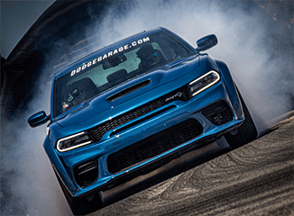 Blue Dodge Charger SRT racing on a track