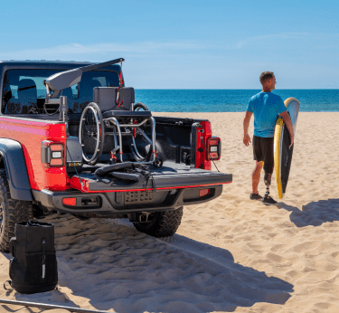 Jeep Gladiator equipped with wheelchair lift parked on beach