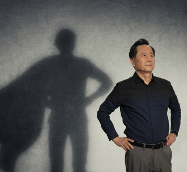 Man posing as superhero with shadow