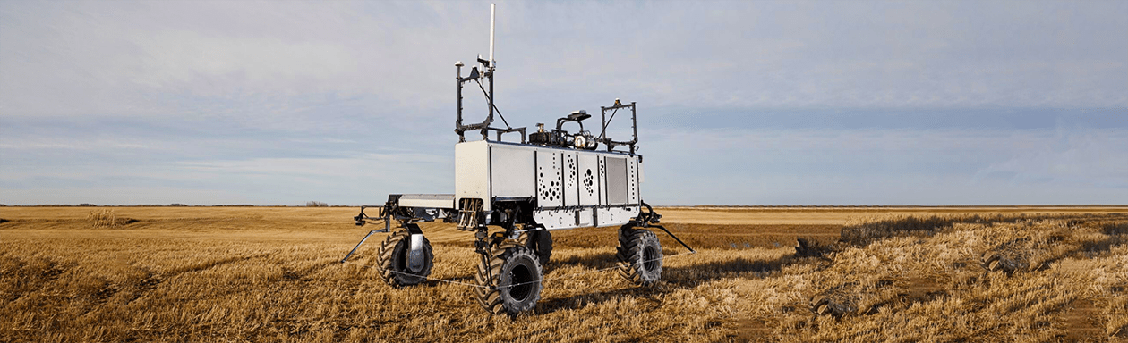 Large autonomous farming equipment driving in field