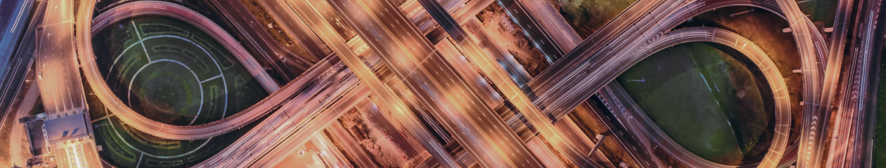 An aerial view of a bustling highway system, with loops and lights galore.