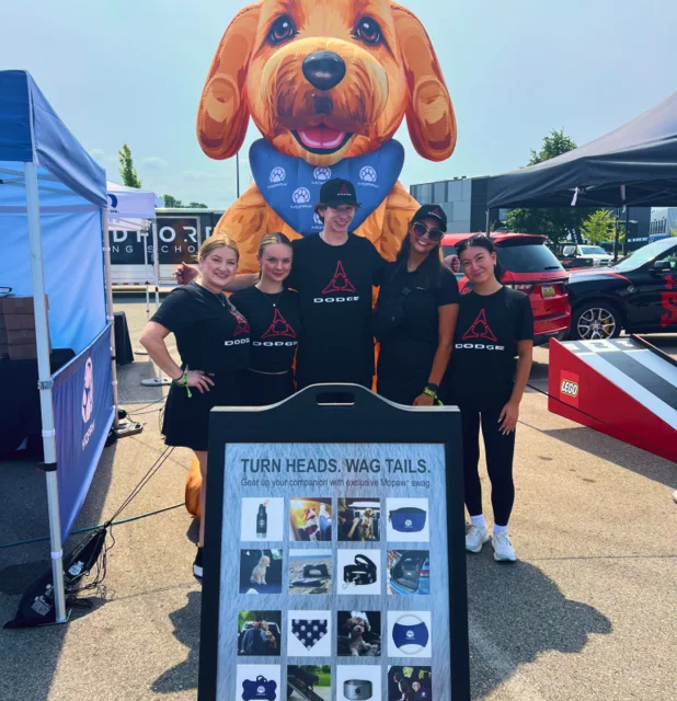 Roadkill Nights mascot beside an event display